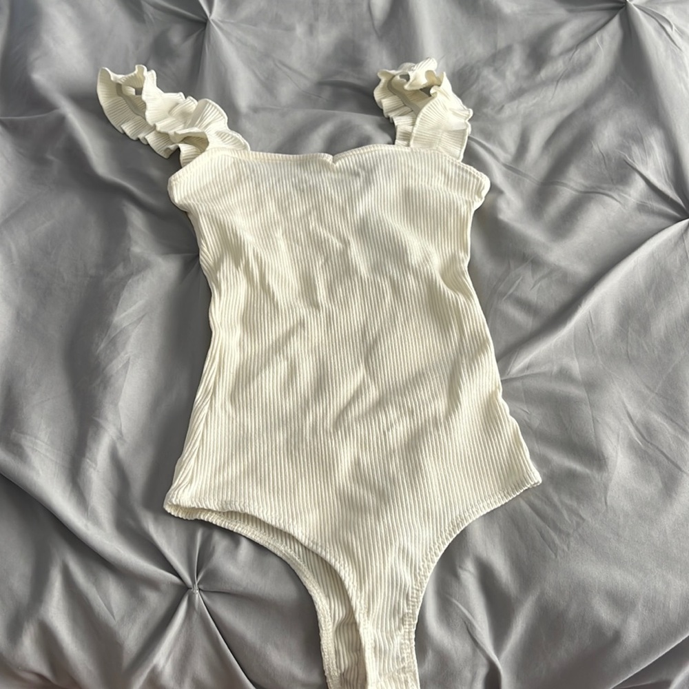 white bodysuit with ruffled straps